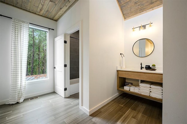 bathroom with hardwood / wood-style floors, lofted ceiling, and wood ceiling