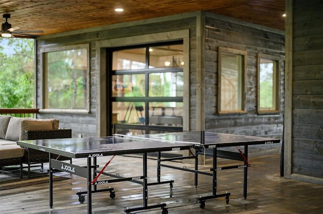 recreation room with ceiling fan, plenty of natural light, wood-type flooring, and wooden ceiling