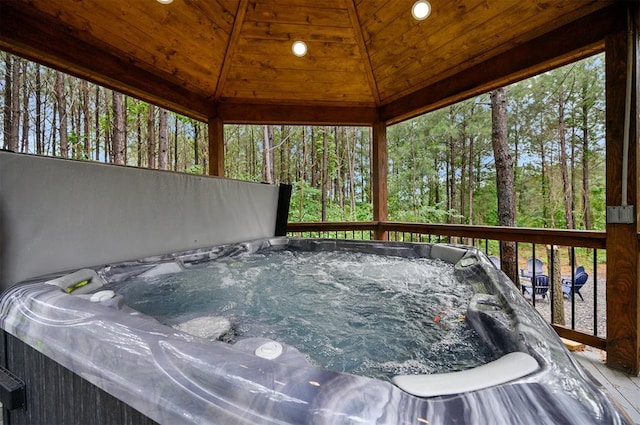 wooden terrace featuring a gazebo and a hot tub