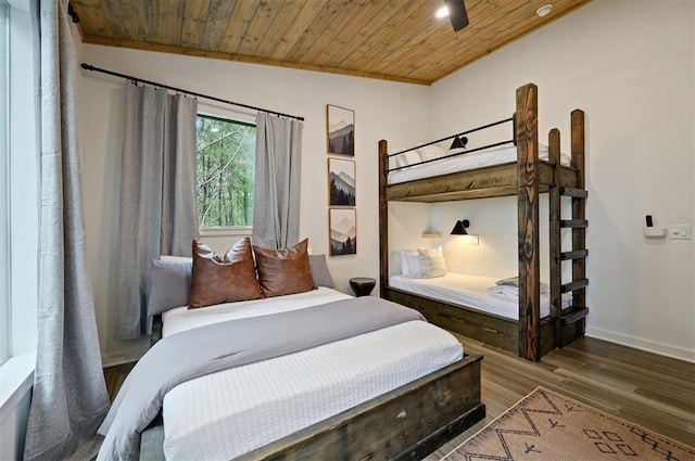 bedroom with lofted ceiling, wood finished floors, wood ceiling, and baseboards