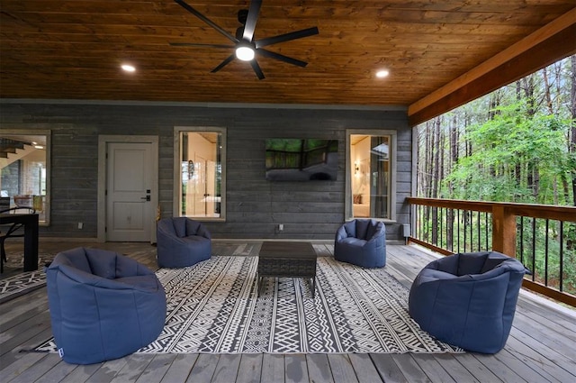 wooden deck featuring outdoor lounge area and a ceiling fan