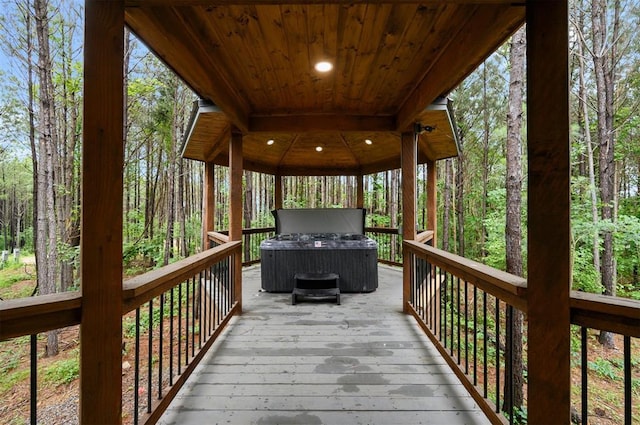 wooden deck featuring a forest view and a gazebo