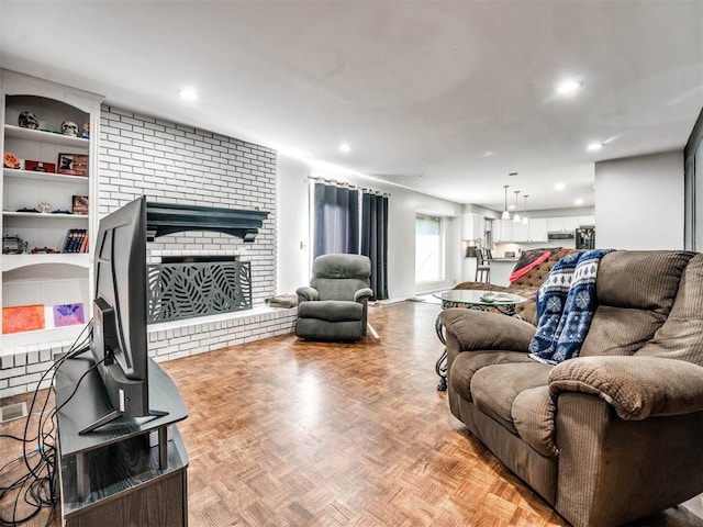 living room featuring light parquet flooring and a brick fireplace