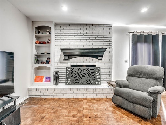 living room featuring a fireplace, built in features, and parquet floors