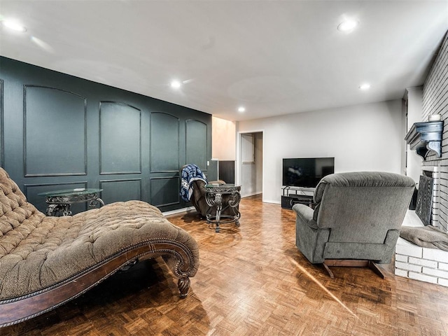 bedroom with a brick fireplace and light parquet flooring