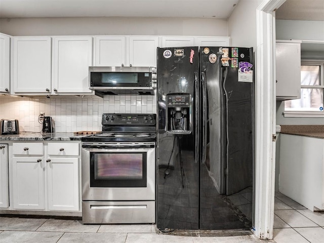 kitchen featuring white cabinets, stainless steel appliances, tasteful backsplash, and light tile patterned flooring