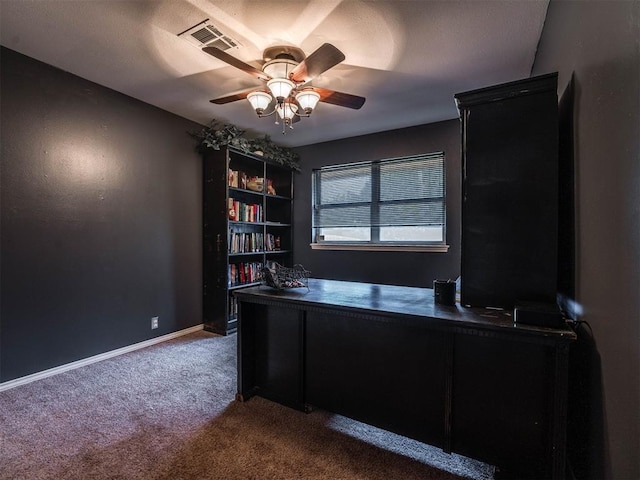 carpeted office featuring ceiling fan