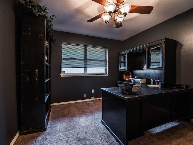 office area with ceiling fan and dark carpet