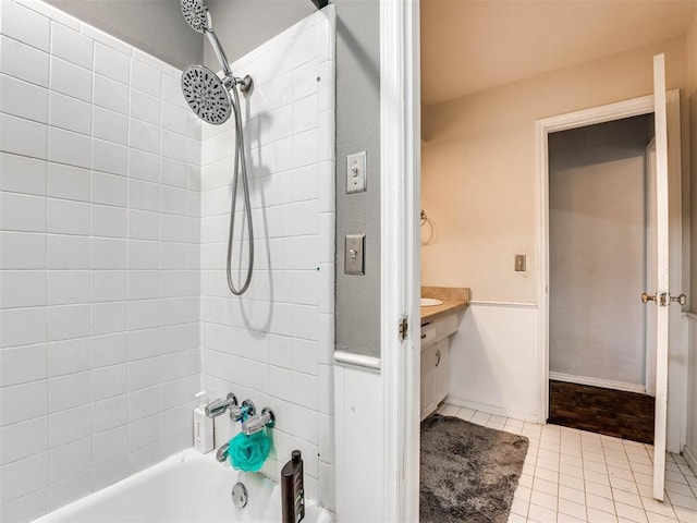 bathroom with tile patterned flooring, vanity, and tiled shower / bath combo