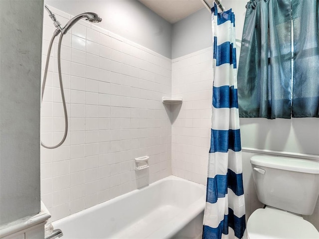 bathroom featuring shower / tub combo with curtain and toilet