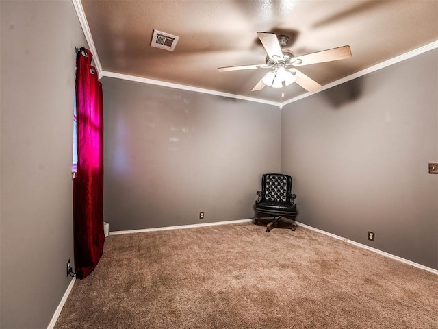 spare room featuring carpet and crown molding