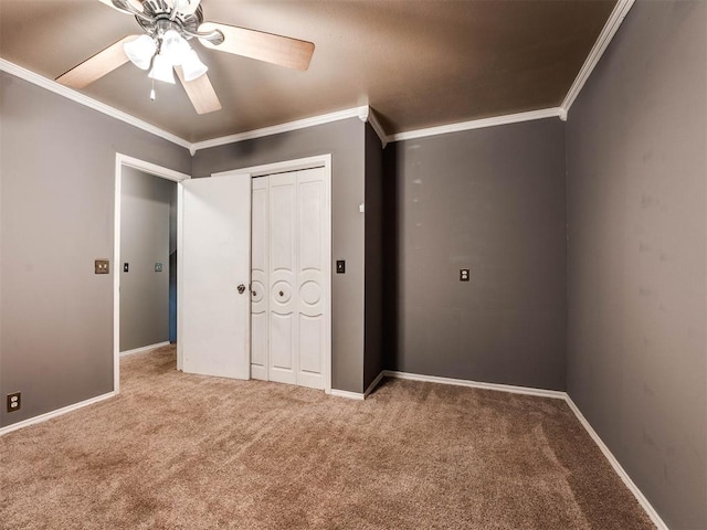 unfurnished bedroom featuring carpet floors, a closet, ceiling fan, and ornamental molding