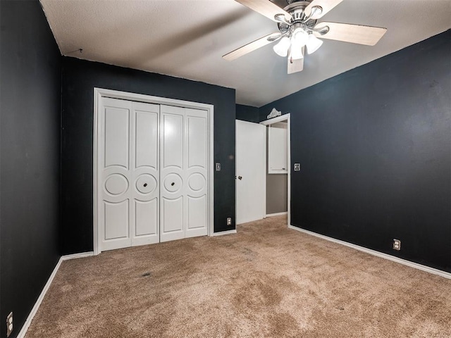 unfurnished bedroom with a closet, ceiling fan, and light colored carpet