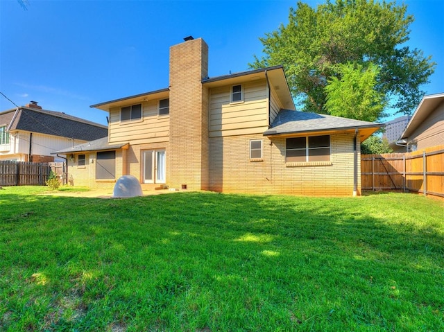 rear view of house with a yard