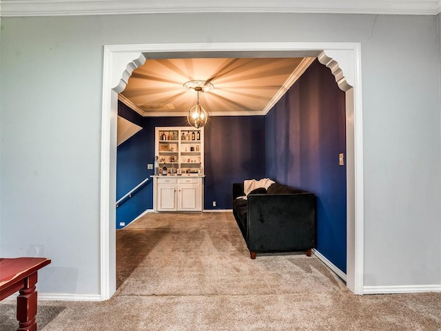 living area featuring carpet floors, an inviting chandelier, and ornamental molding