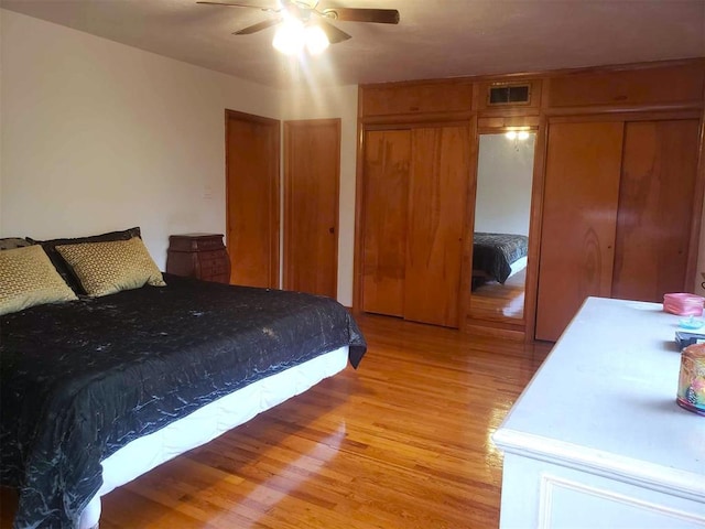 bedroom with ceiling fan and light hardwood / wood-style flooring