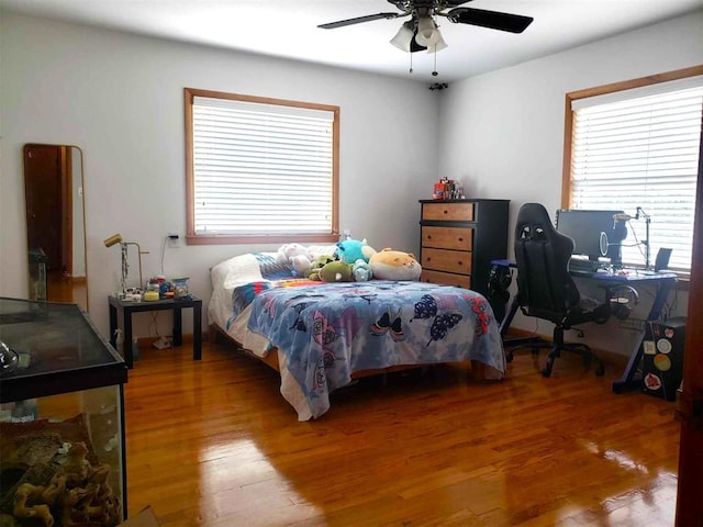 bedroom featuring hardwood / wood-style flooring and ceiling fan