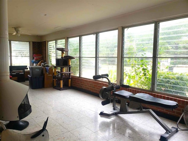 sunroom with ceiling fan and a healthy amount of sunlight