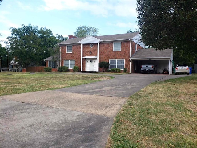 view of front of house with a front lawn and a carport