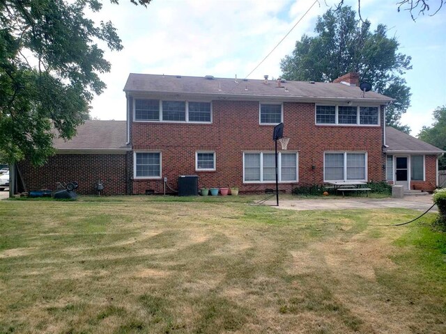 rear view of property featuring a lawn