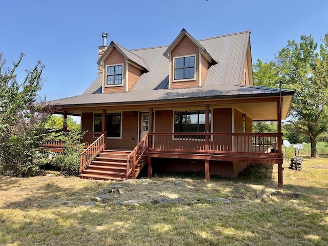 farmhouse inspired home with covered porch and a front lawn