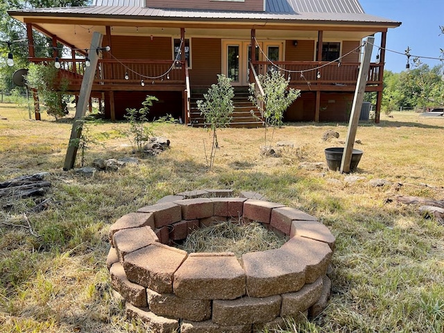 back of property with covered porch and central air condition unit