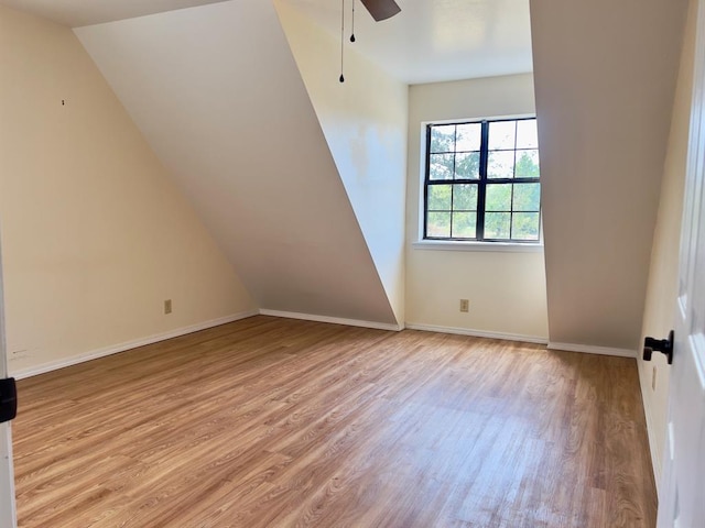 additional living space featuring light wood-type flooring, vaulted ceiling, and ceiling fan