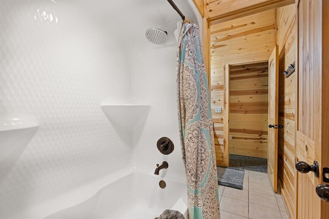 bathroom featuring tile patterned flooring, wood walls, and shower / tub combo