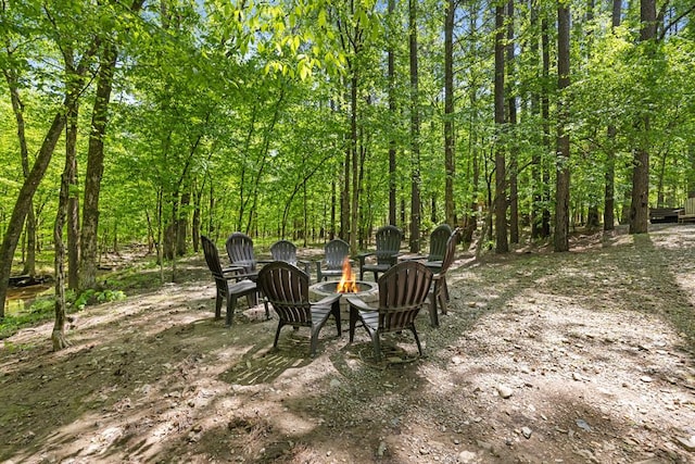 view of yard featuring an outdoor fire pit