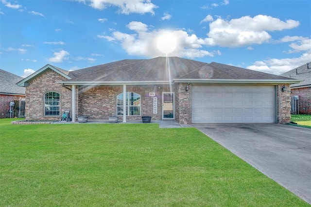 ranch-style home featuring a front yard and a garage