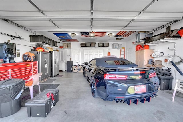 garage with stainless steel refrigerator with ice dispenser