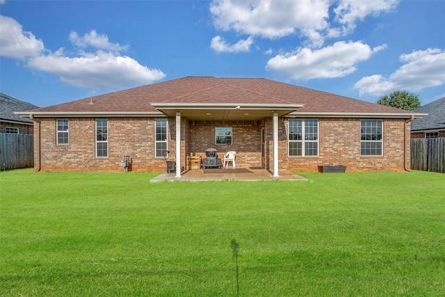 back of property featuring a patio area and a yard