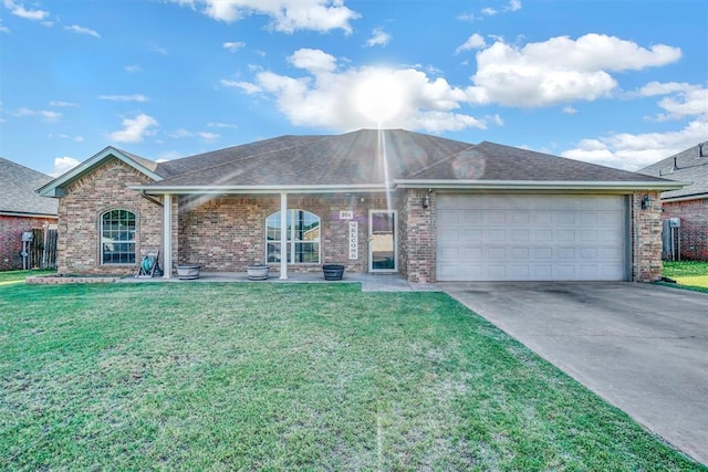 ranch-style home with a garage and a front yard