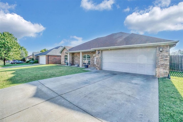 ranch-style home featuring a garage and a front lawn