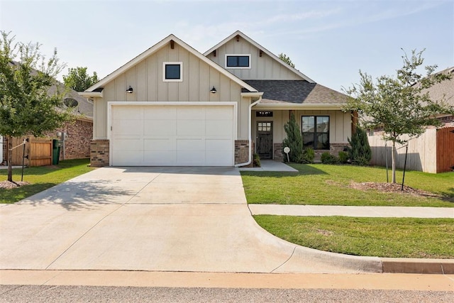 view of front of home with a garage and a front lawn