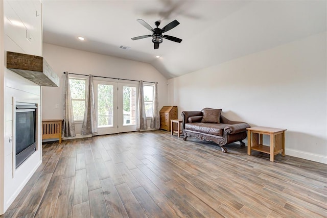 living area featuring ceiling fan, lofted ceiling, and hardwood / wood-style flooring