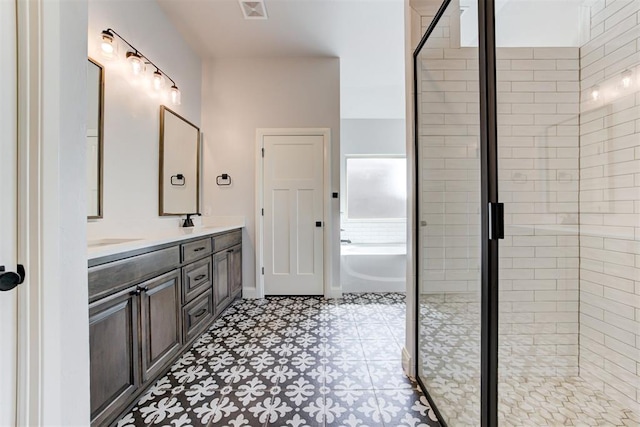 bathroom with plus walk in shower, vanity, and tile patterned floors