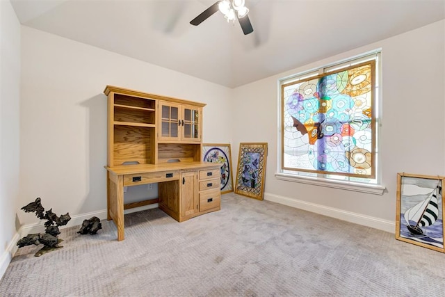 carpeted office space with ceiling fan