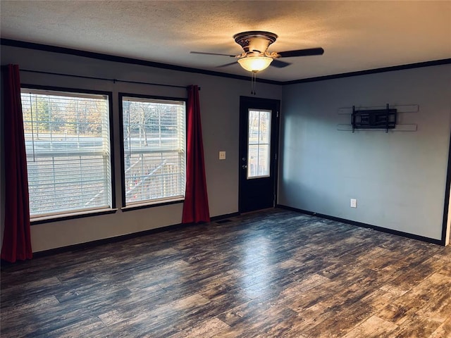 spare room featuring a textured ceiling, dark hardwood / wood-style floors, ceiling fan, and crown molding