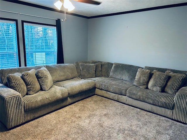 carpeted living room featuring ceiling fan, ornamental molding, and a textured ceiling