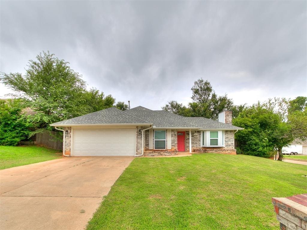 1925 NE Overland Trl, Choctaw, OK 73020 - ranch-style home with a garage, driveway, a chimney, and brick siding