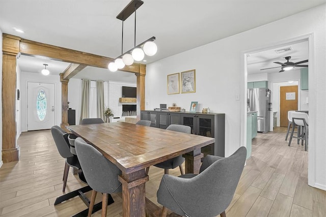 dining area with ceiling fan and light hardwood / wood-style floors