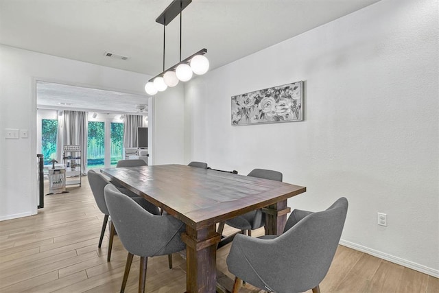 dining area with light hardwood / wood-style floors