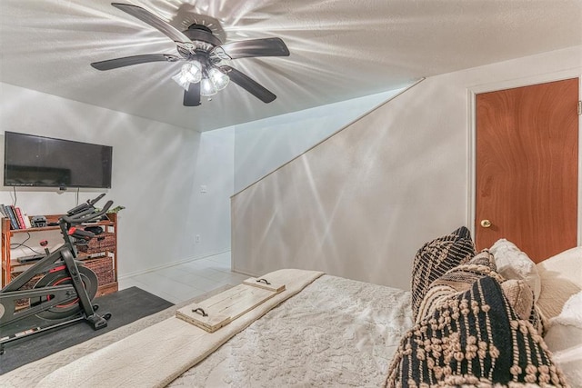 interior space with ceiling fan and a textured ceiling