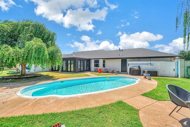 view of swimming pool featuring a yard and a patio