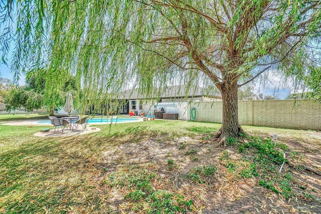 view of yard featuring a patio and a fenced in pool