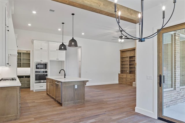 kitchen featuring white cabinetry, ceiling fan, stainless steel appliances, light hardwood / wood-style floors, and a kitchen island with sink