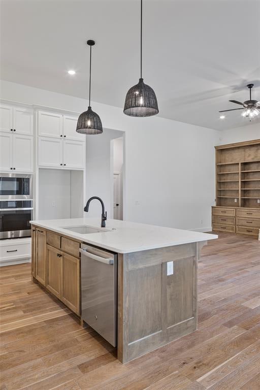 kitchen with white cabinets, sink, an island with sink, and appliances with stainless steel finishes