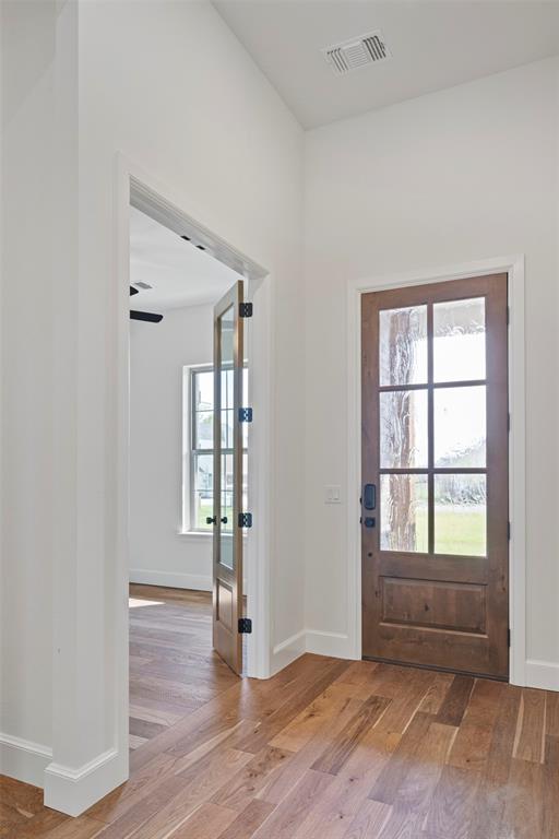 entryway with ceiling fan and light wood-type flooring