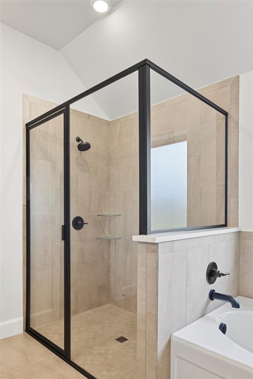 bathroom featuring tile patterned flooring and separate shower and tub